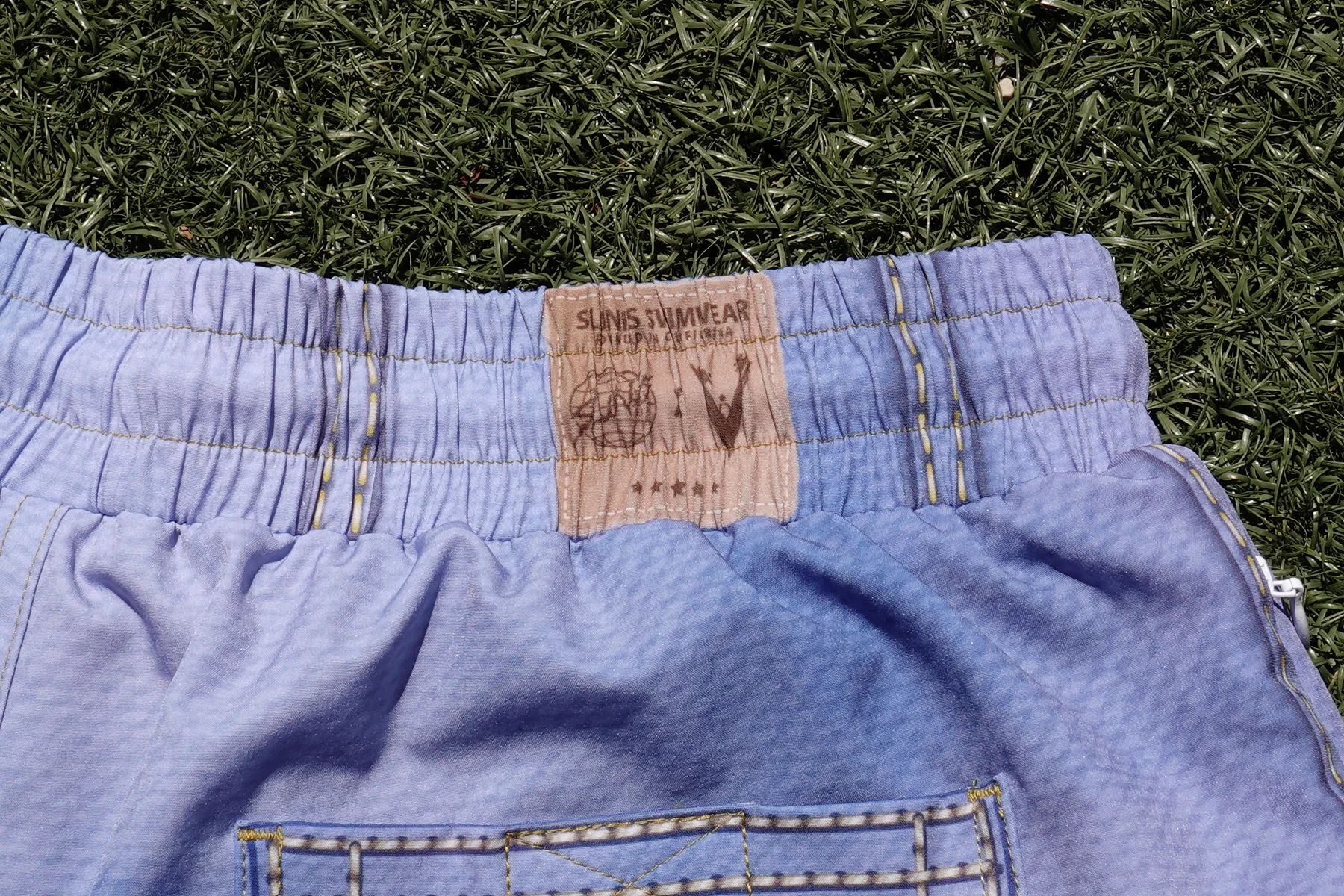 Slunks Swimwear and Volleyball Guys collaboration label stitched into the JORTS waistband